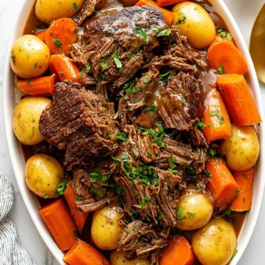 Delicious Crock Pot Chuck Roast cooking with vegetables and spices.