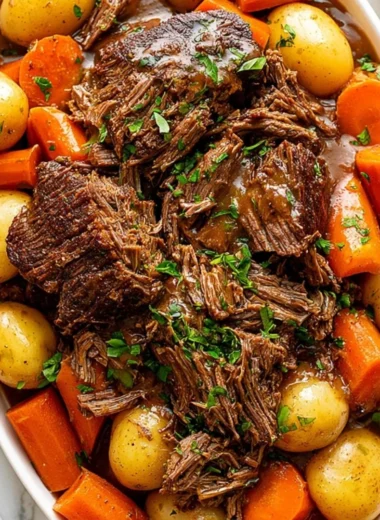 Delicious Crock Pot Chuck Roast cooking with vegetables and spices.