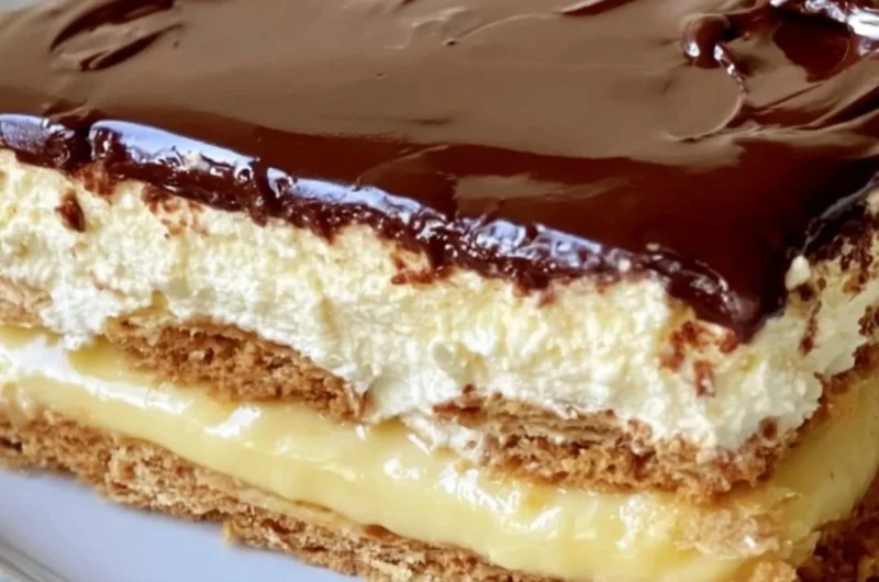 Delicious no-bake eclair cake topped with chocolate frosting and whipped cream