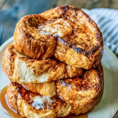 Delicious slice of the best French toast topped with syrup and berries