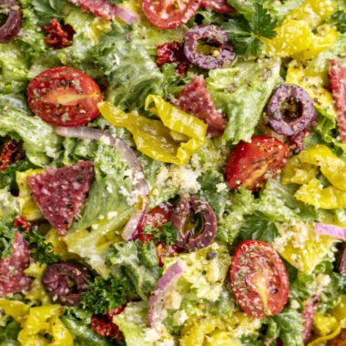 Bowl of classic Italian salad with fresh vegetables and dressing