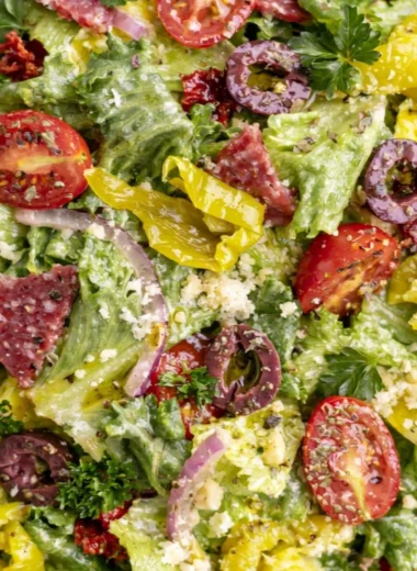 Bowl of classic Italian salad with fresh vegetables and dressing