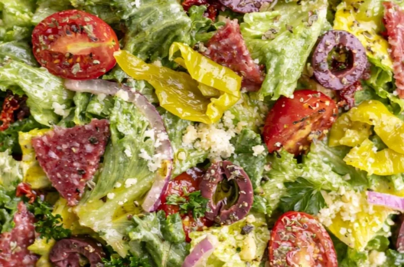 Bowl of classic Italian salad with fresh vegetables and dressing