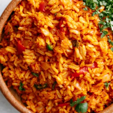 Bowl of easy Mexican rice garnished with herbs and served as a side dish.