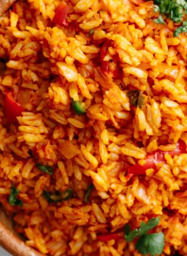 Bowl of easy Mexican rice garnished with herbs and served as a side dish.