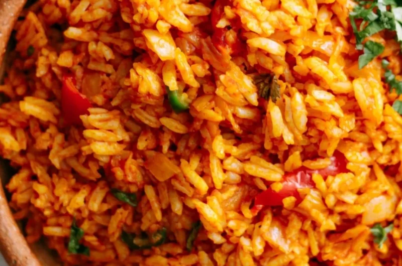 Bowl of easy Mexican rice garnished with herbs and served as a side dish.