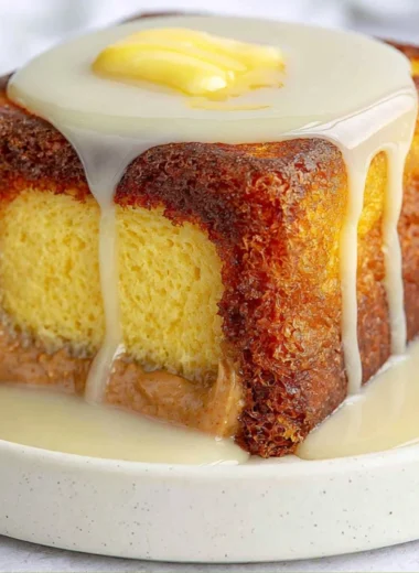 Hong Kong Style French Toast served with syrup and butter on a plate.