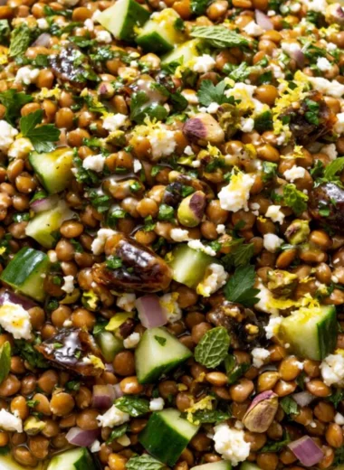 A vibrant Lentil Salad with Feta cheese, herbs, and vegetables in a bowl.