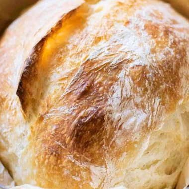 Loaf of freshly baked no-fail sourdough bread on a wooden table