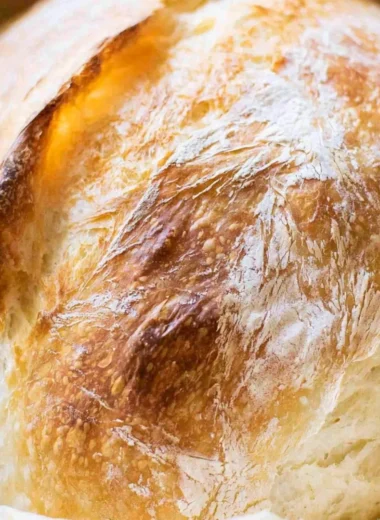Loaf of freshly baked no-fail sourdough bread on a wooden table