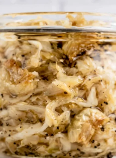 Delicious roasted garlic sauerkraut served in a bowl, showcasing its texture and color