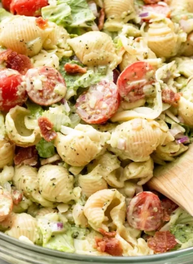 A vibrant bowl of BLT Pasta Salad with bacon, lettuce, and tomatoes.