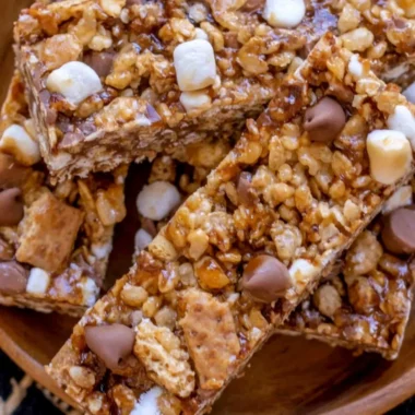 Homemade granola bars filled with nuts and dried fruits on a wooden table