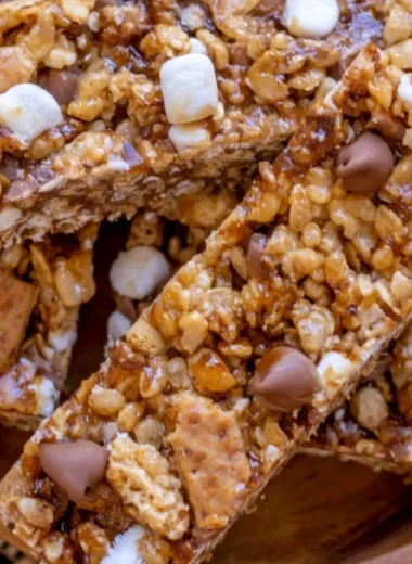 Homemade granola bars filled with nuts and dried fruits on a wooden table