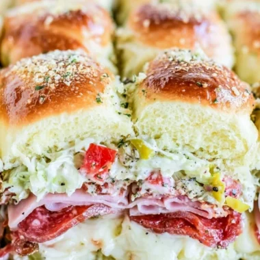 Delicious Italian grinder sliders served on a platter with fresh ingredients