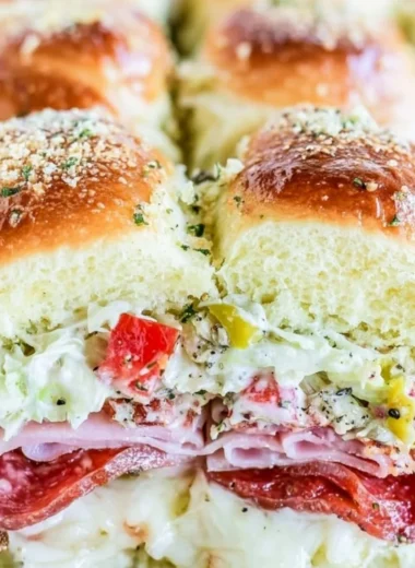 Delicious Italian grinder sliders served on a platter with fresh ingredients